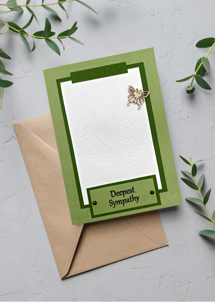 the deepest sympathy card siting with a light brown envelope on a neutral grey backdrop