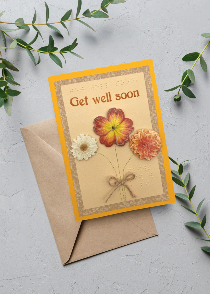 the get well soon card with a brown envelope on a neutral grey backdrop
