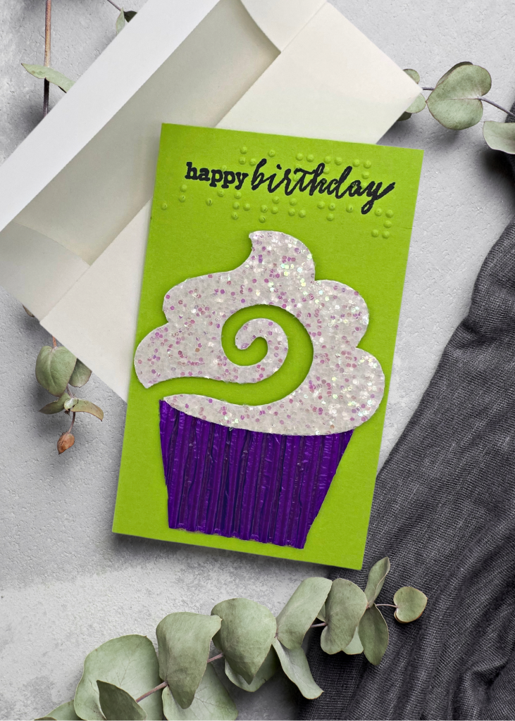 the birthday card with a white envelope on a neutral grey backdrop